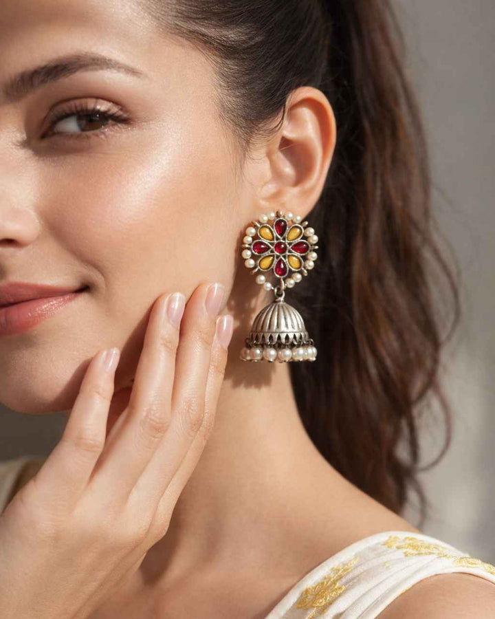 Woman wearing a decorative earring with a blurred background
