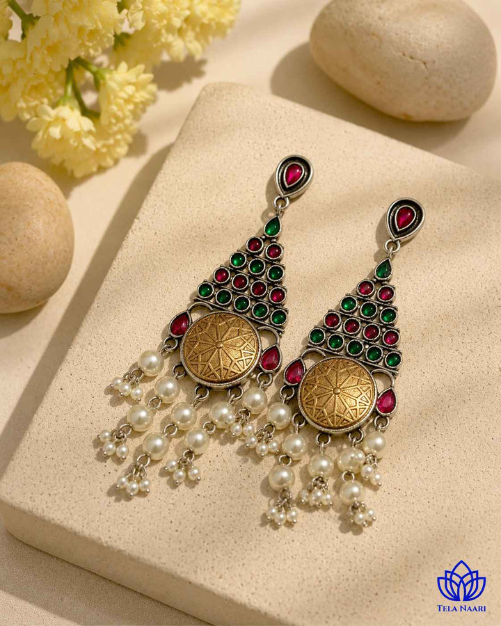 Structured brass construction forms the base of this drop-style earring.
