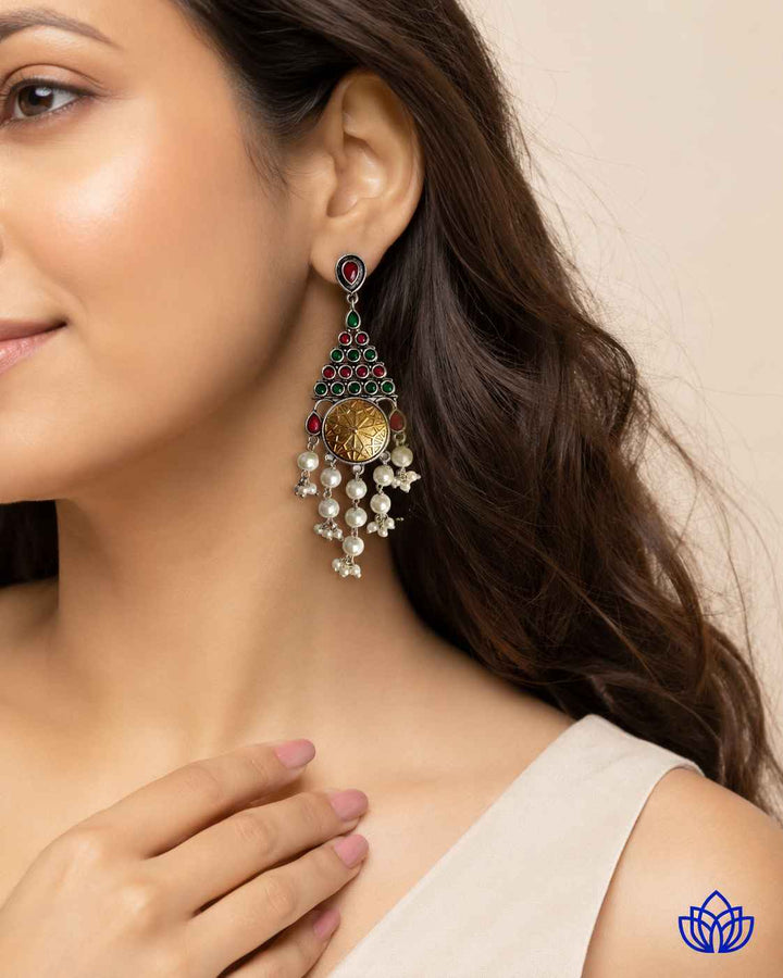 Elongated silhouette pairs everyday versatility with dual-tone plating.