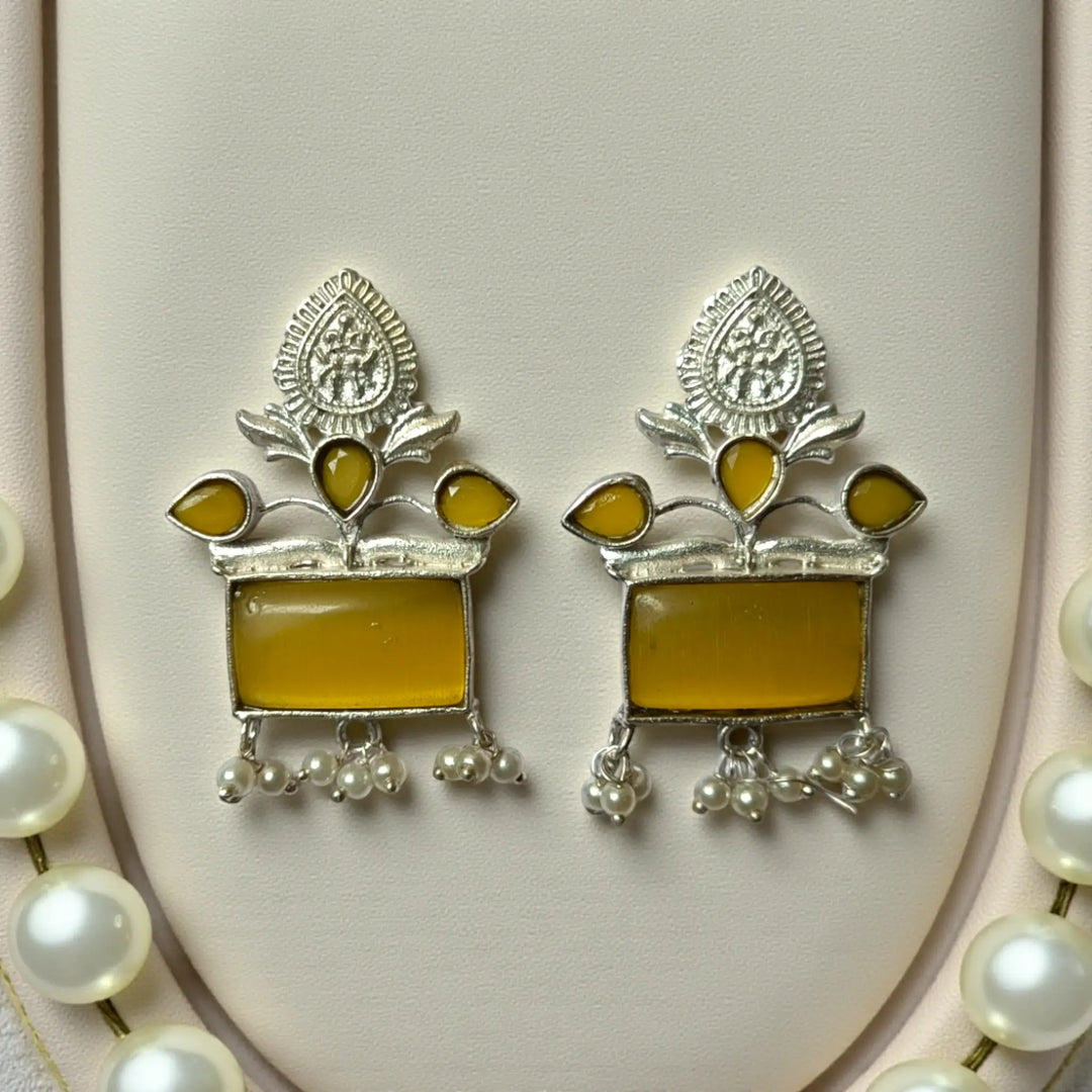 Brass construction supports the lightweight pearl dangler design.