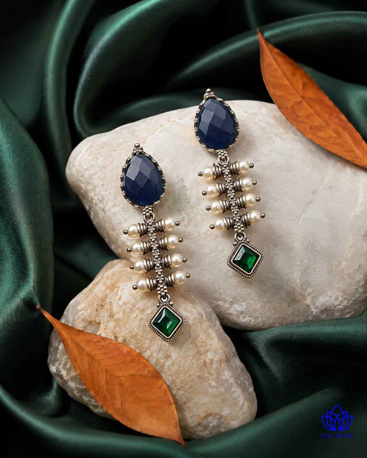 Brass construction supports the soft teardrop shape of this earring.