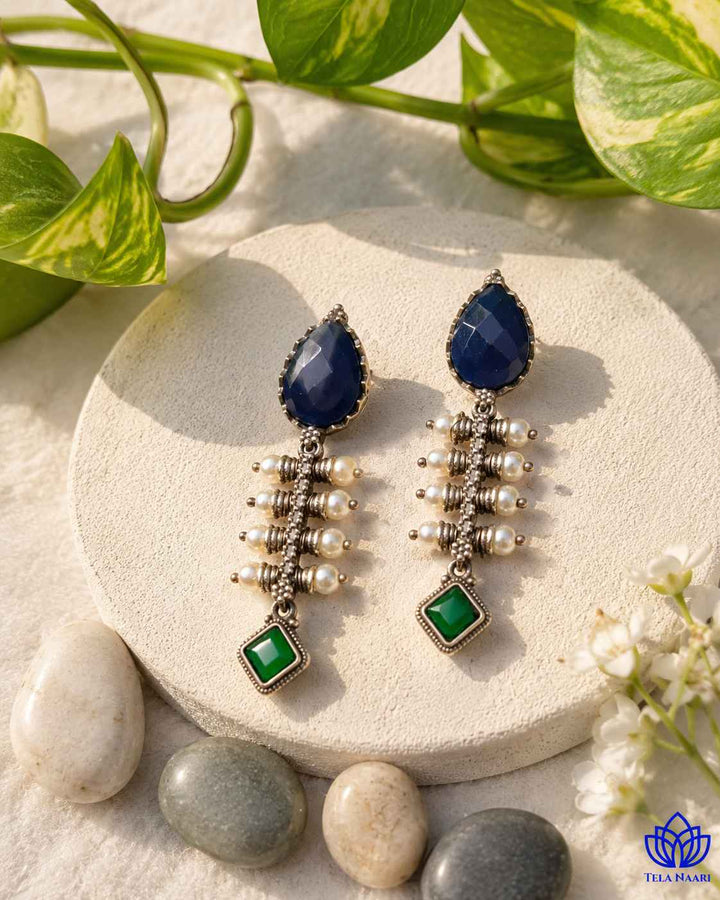 Teardrop silhouette pairs a silver-plated finish with cool blue tones.