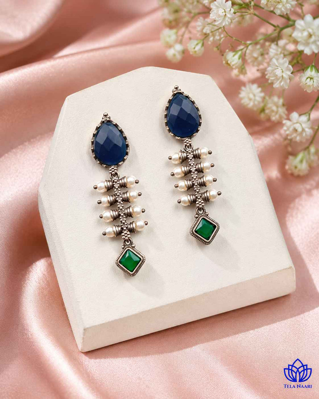 Blue tone brightens the teardrop silhouette of this earring.