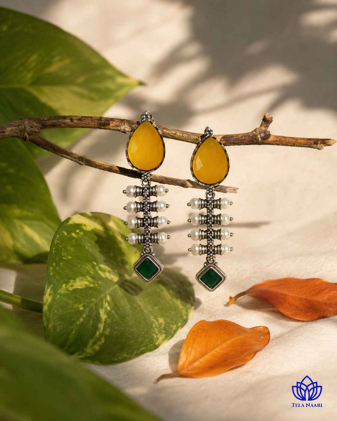 Brass construction supports the soft teardrop shape of this earring.