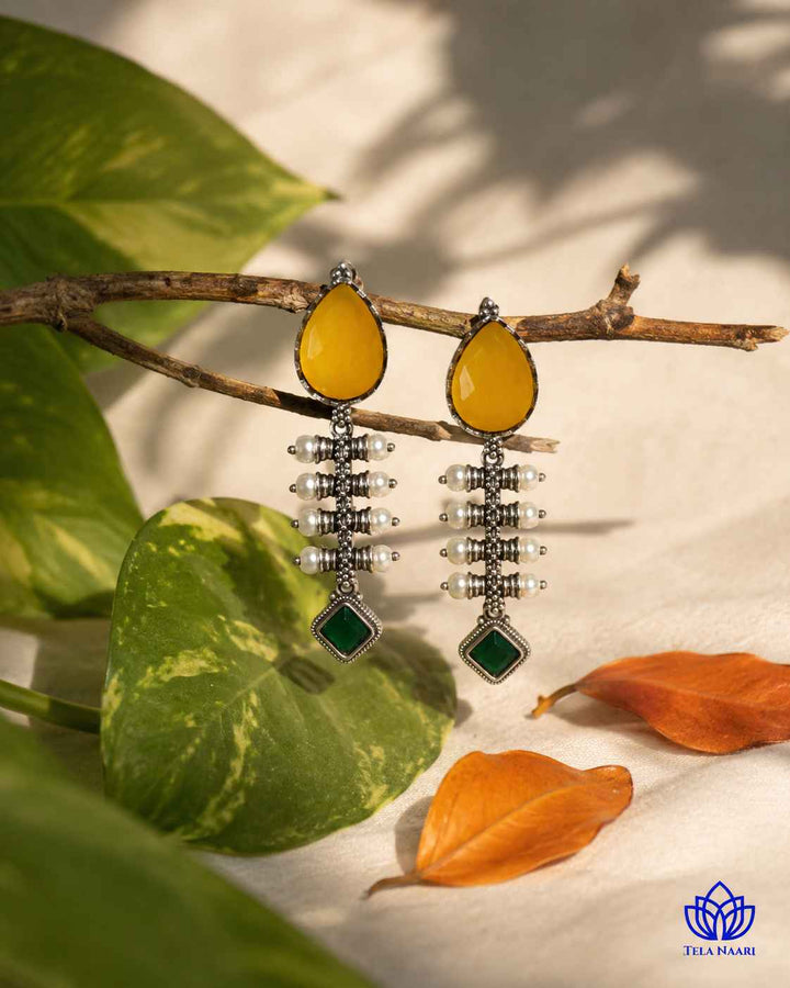 Brass construction supports the soft teardrop shape of this earring.