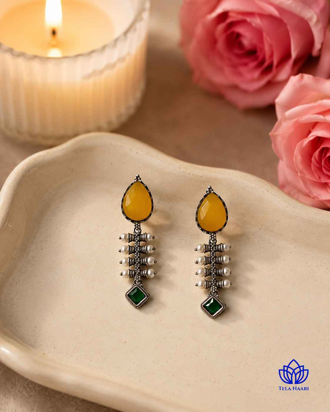 Golden-yellow hues brighten the silver-plated surface of this earring.