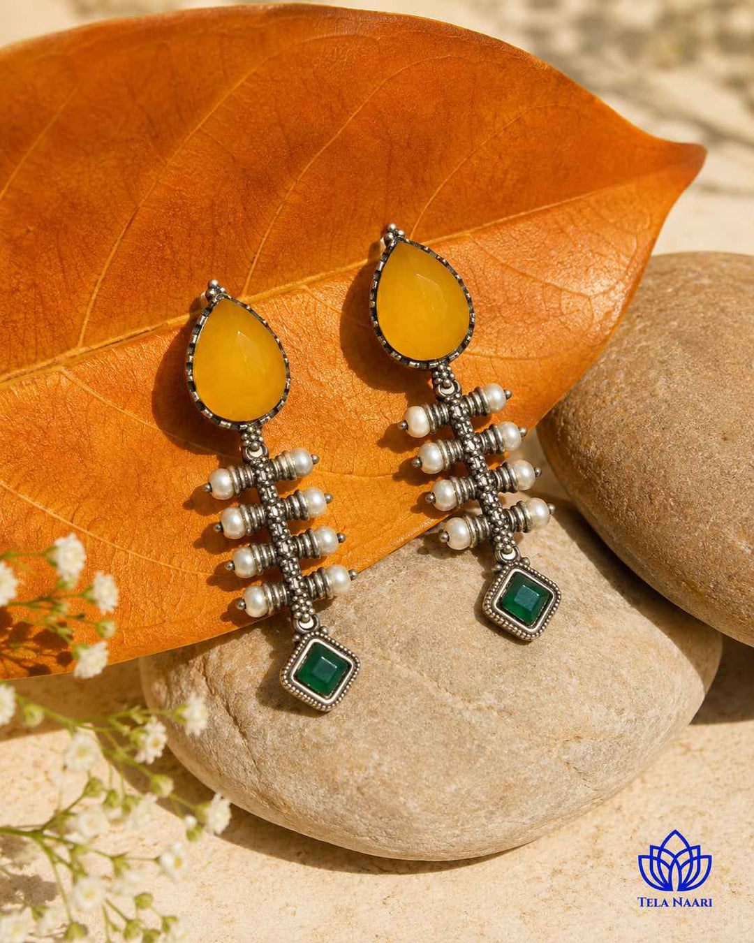 Yellow tone brightens the teardrop silhouette of this earring.