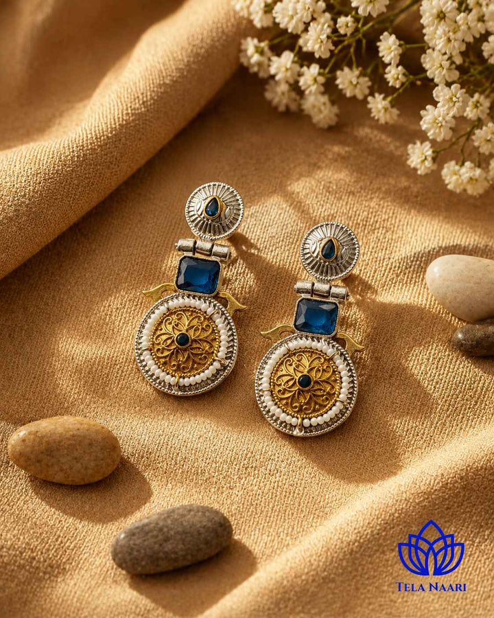 Brass construction underlies the oxidised dual-tone plating on this earring.