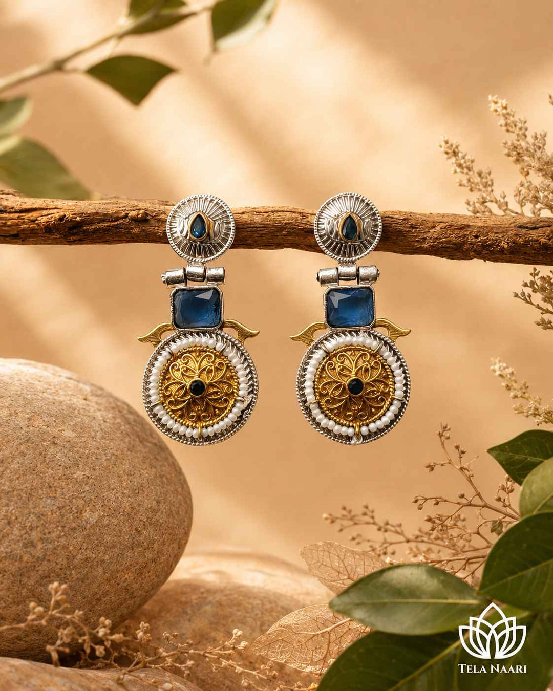 Traditional craftsmanship shapes the silhouette of this dual-tone earring.