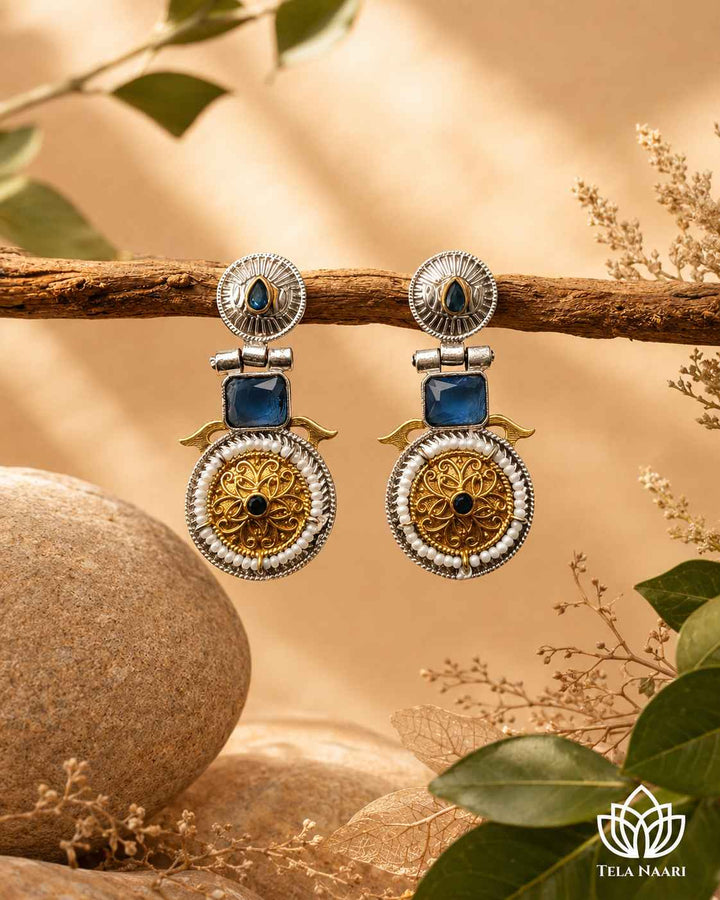 Traditional craftsmanship shapes the silhouette of this dual-tone earring.