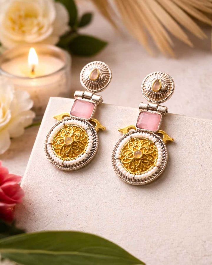 Brass construction supports the dual-tone plating of this earring.