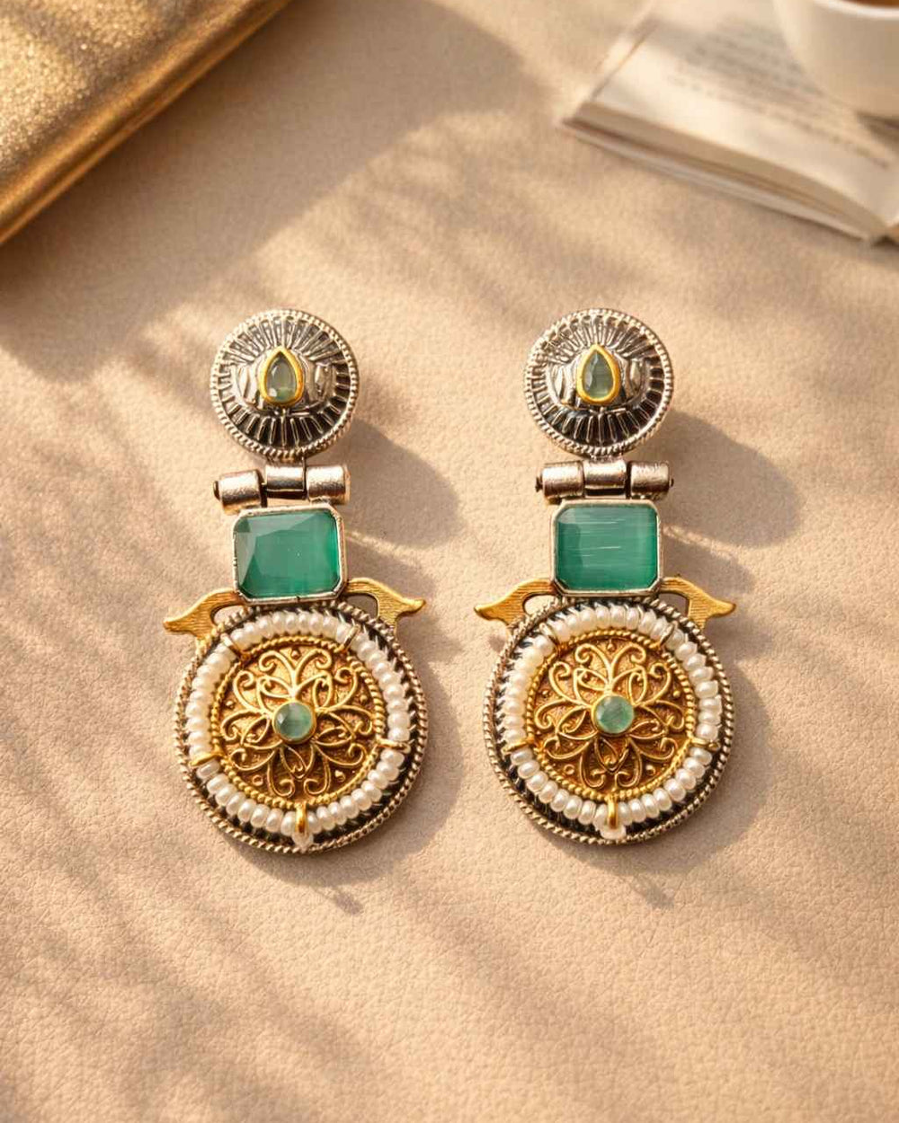 Silver oxidised finish covers half of this dual-tone sea green earring.