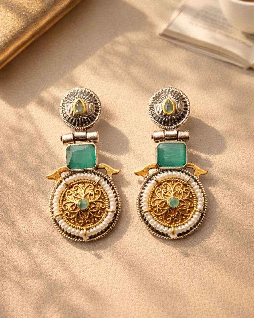 Silver oxidised finish covers half of this dual-tone sea green earring.