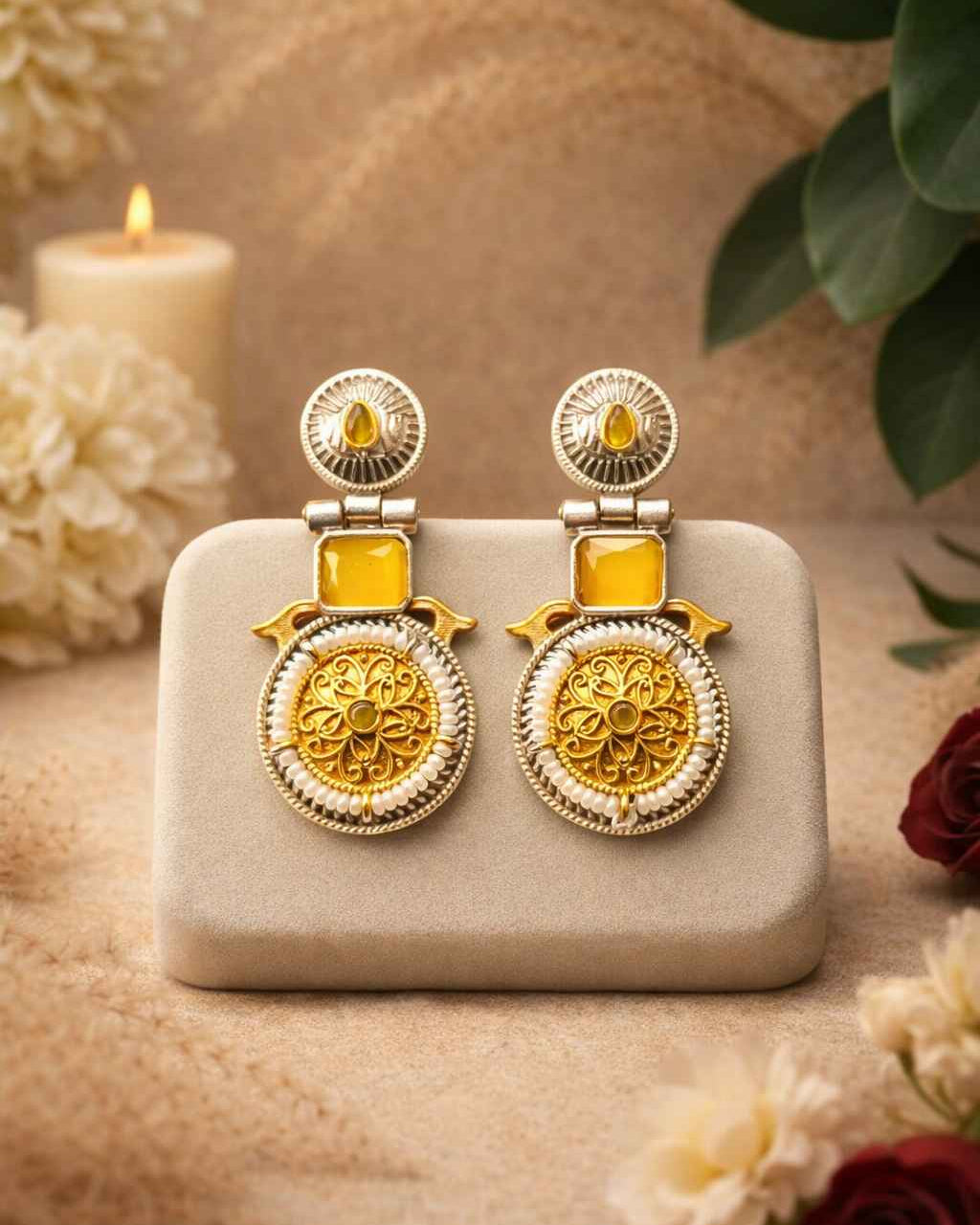 Radiant yellow tones brighten the dual-tone surface of this earring.