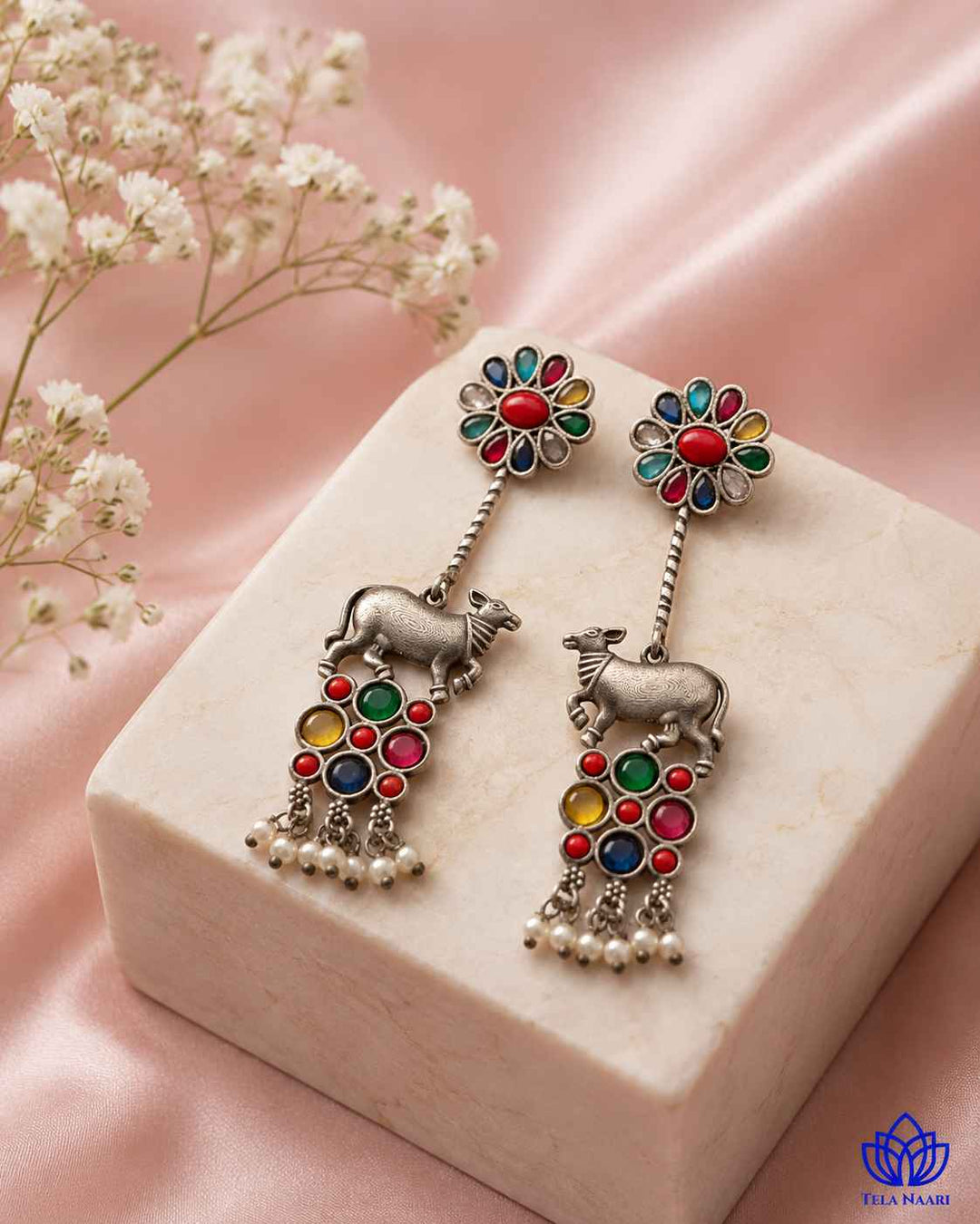 Brass construction supports the intricate craftsmanship of this earring.