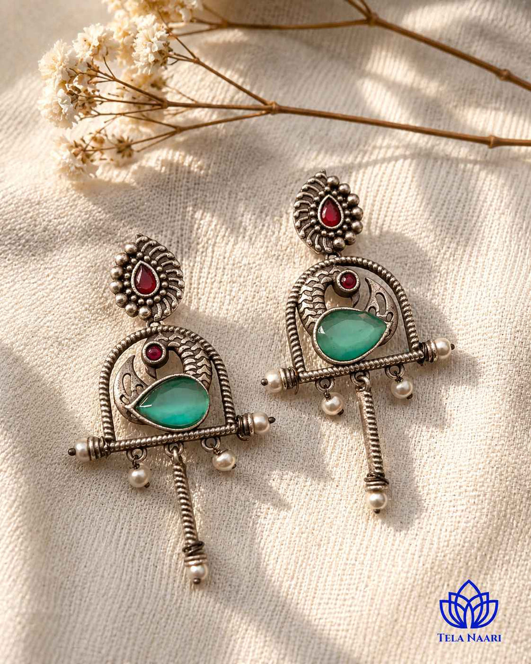 Artificial stone accents highlight the centre of this green earring.