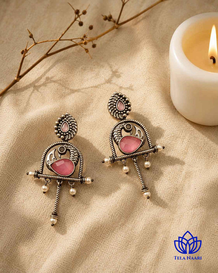 Artificial stone accents highlight the centre of this pink earring.