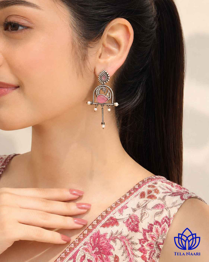 Brass construction supports the oxidised finish of this pink earring.