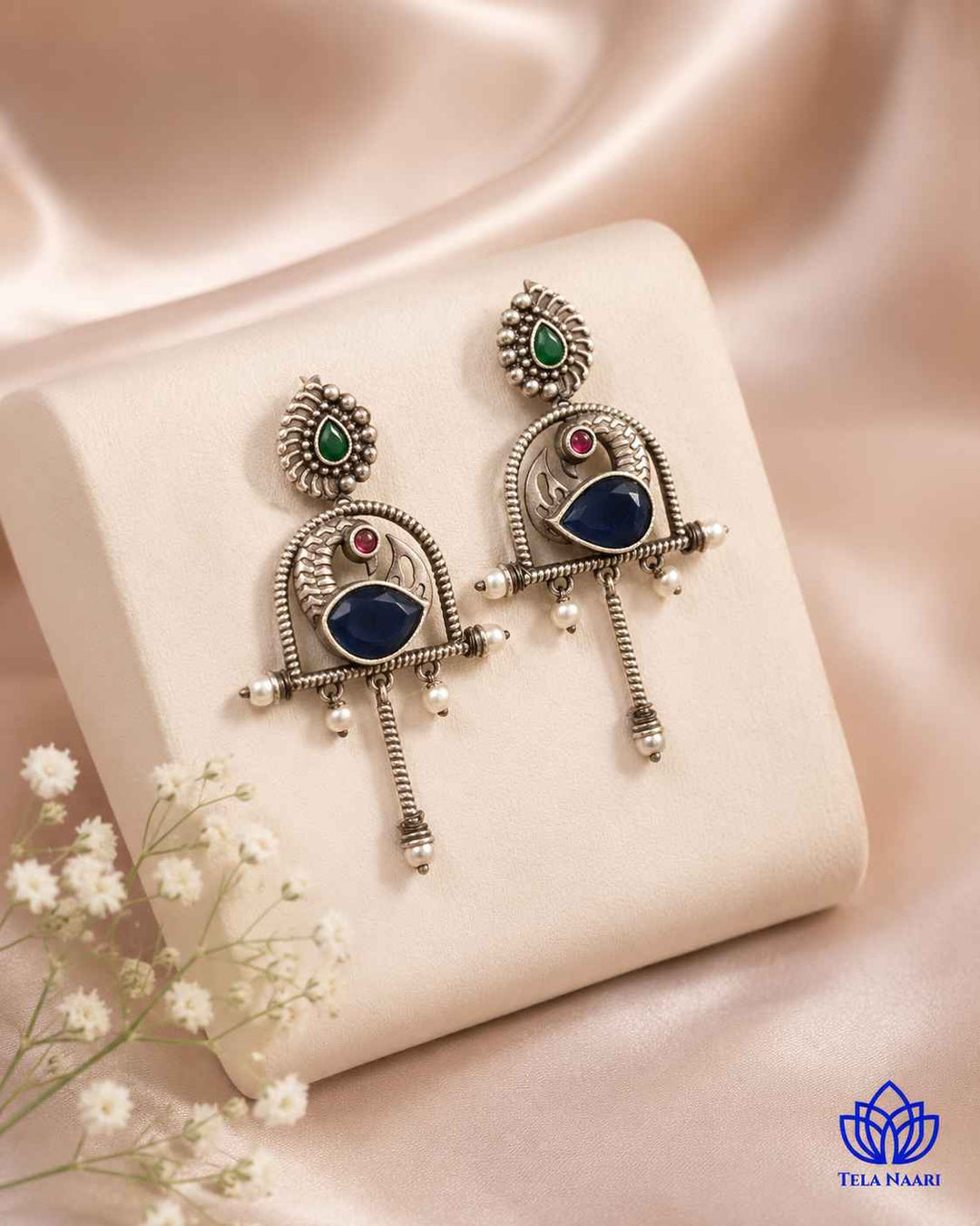 Handcrafted glass bead detailing brings a distinct touch to this earring.