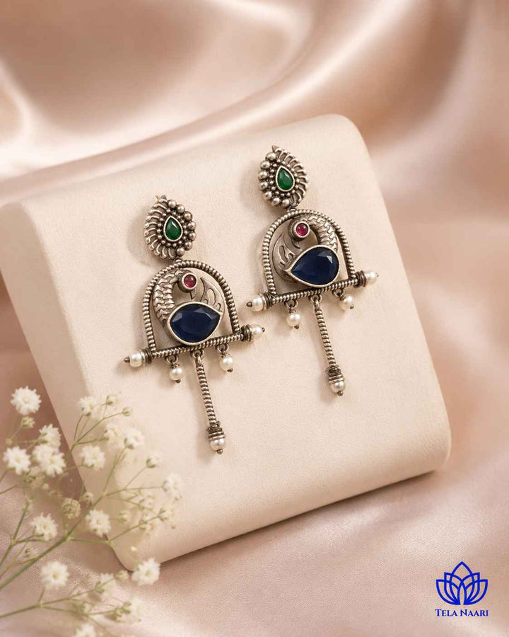 Handcrafted glass bead detailing brings a distinct touch to this earring.