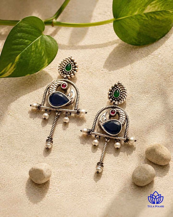 Layered oxidised plating gives this blue earring its textured finish.