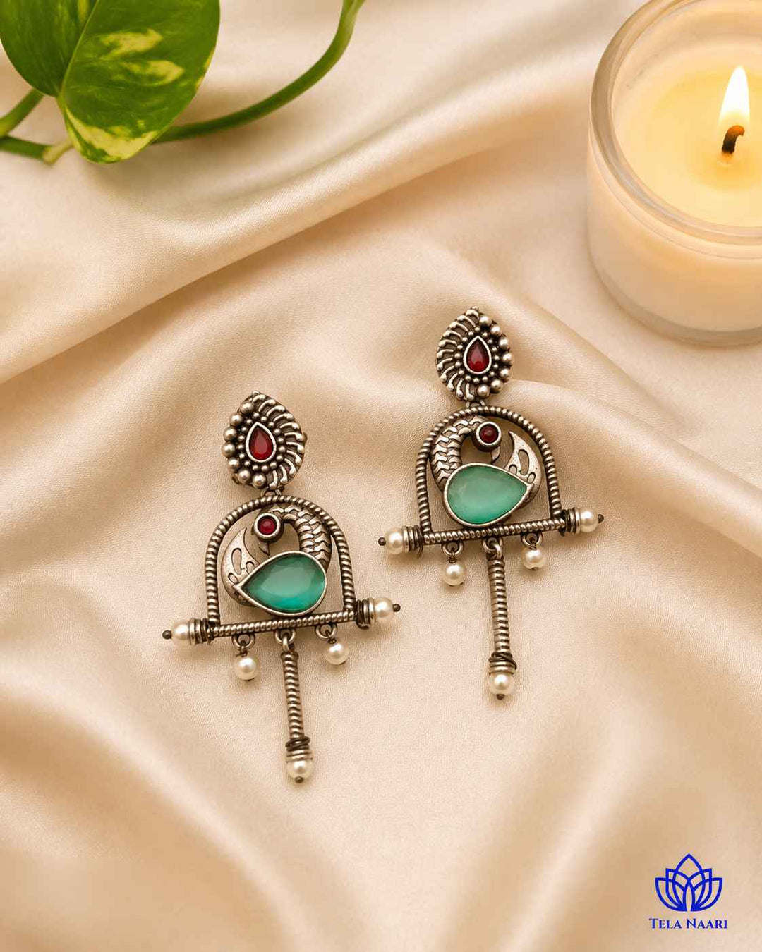 Post and back closure secures this oxidised green earring in place.