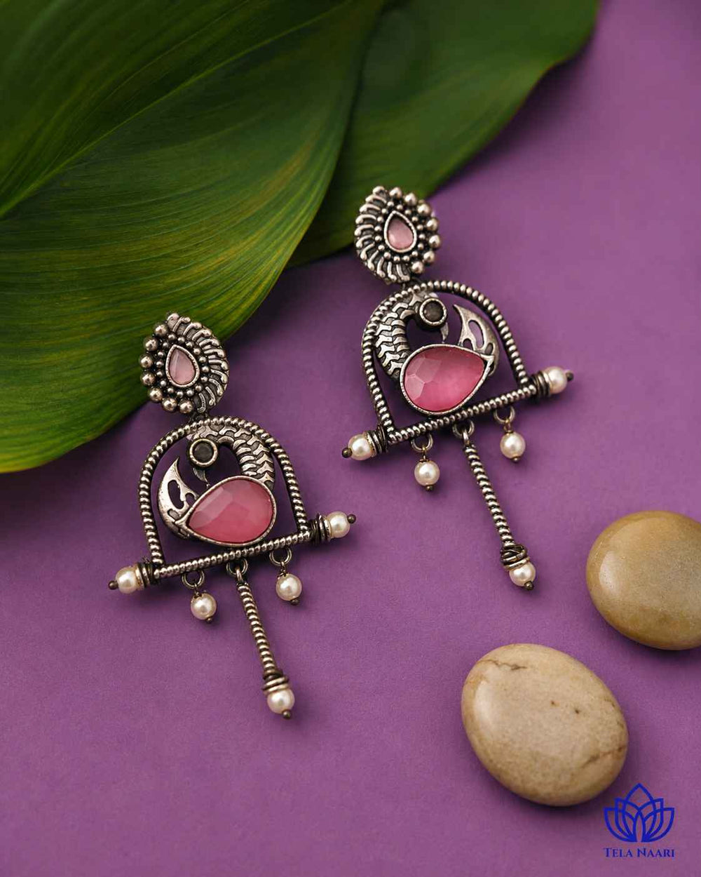 Silver oxidised finish covers the surface of this pink earring.
