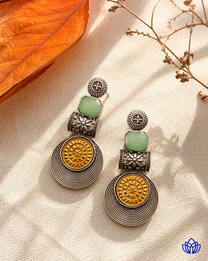Layered finish gives this light green earring its confident structure.