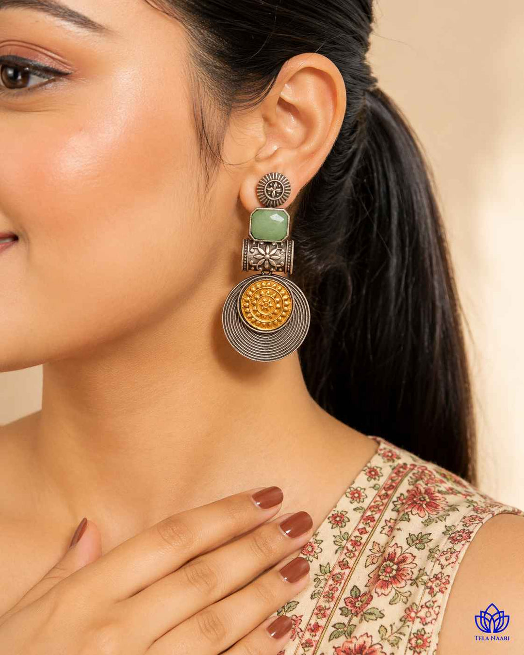Push-back stopper closure secures this dual-tone statement earring.
