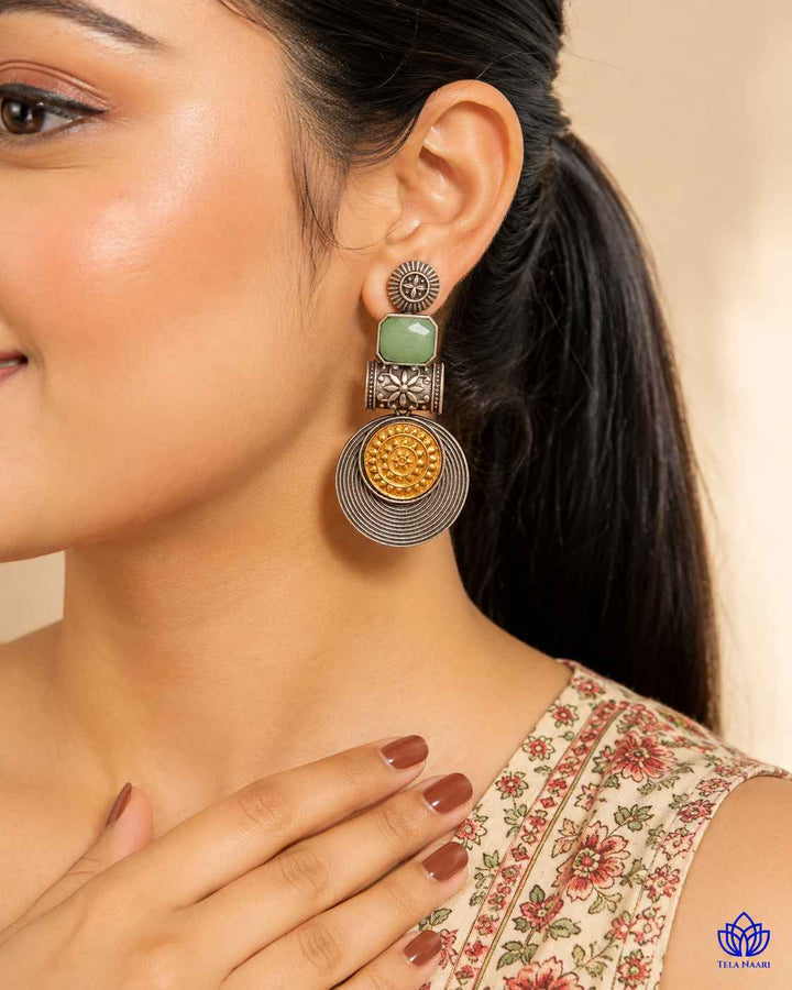 Push-back stopper closure secures this dual-tone statement earring.