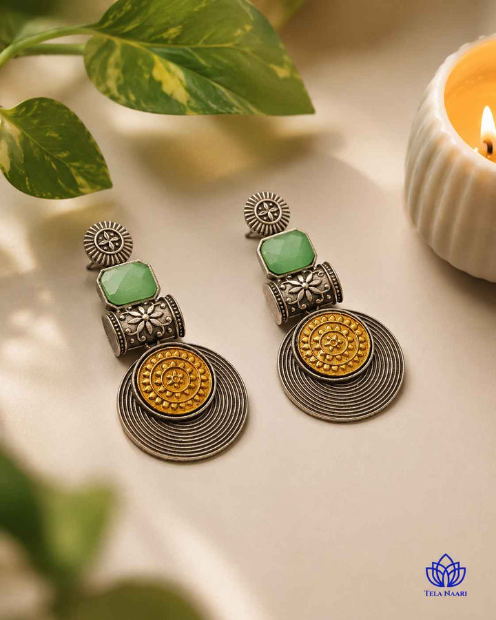 Bold green accents stand out against the silver-plated tone.
