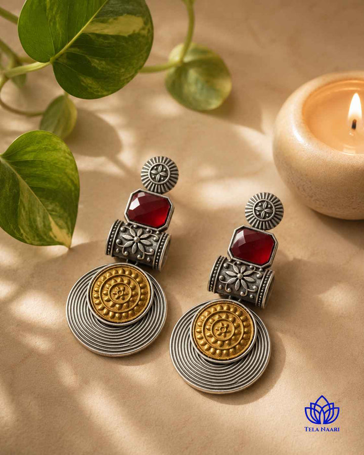 Contrast plating blends red and silver tones on this earring.