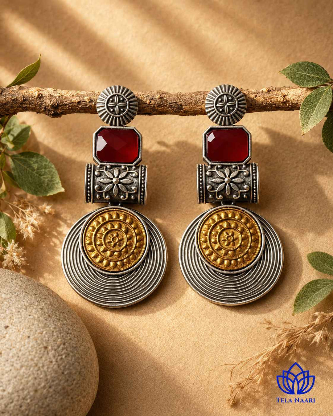 Layered plating gives this red earring its bold structure.