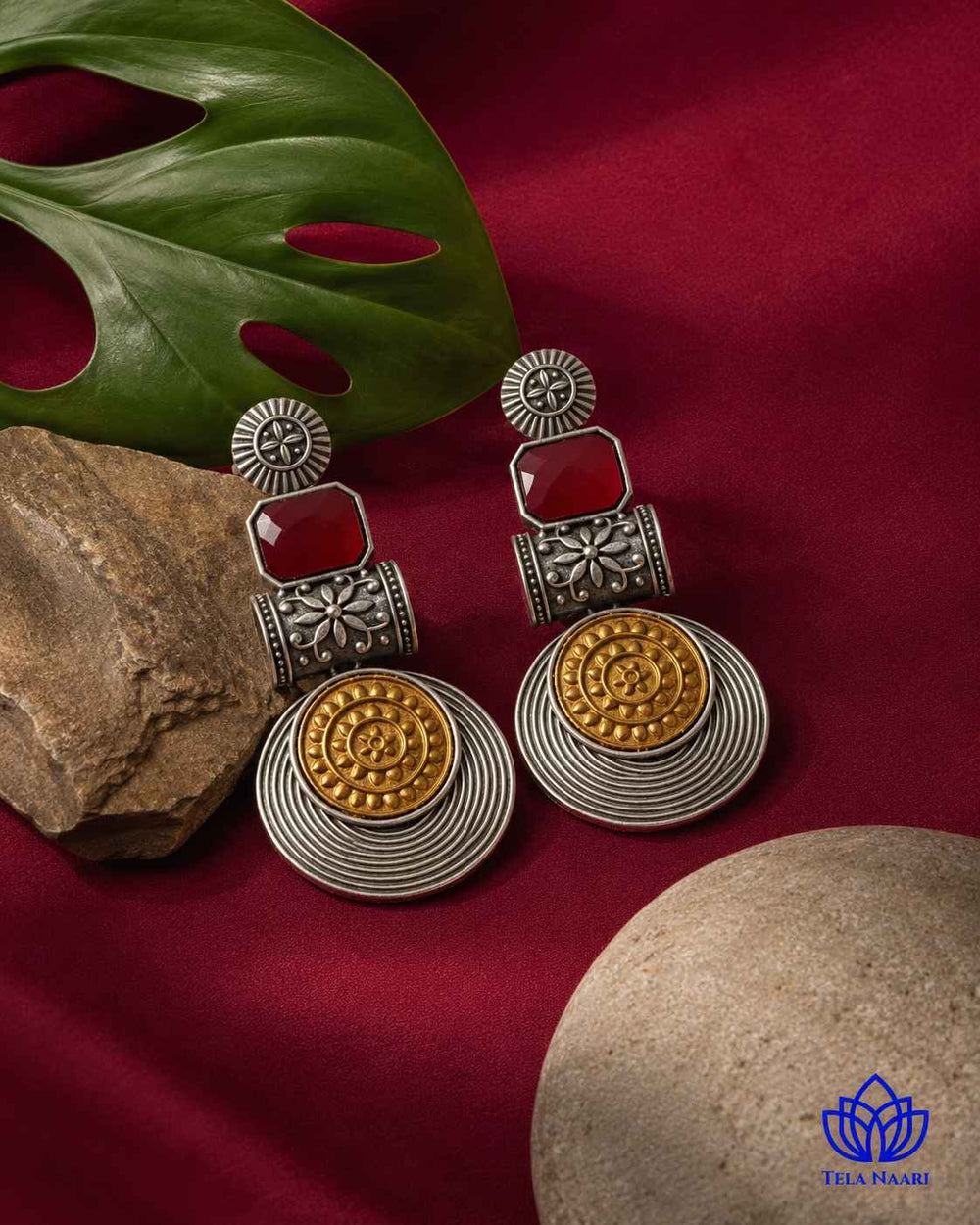 Silver-plated finish covers half of this dual-tone red earring.