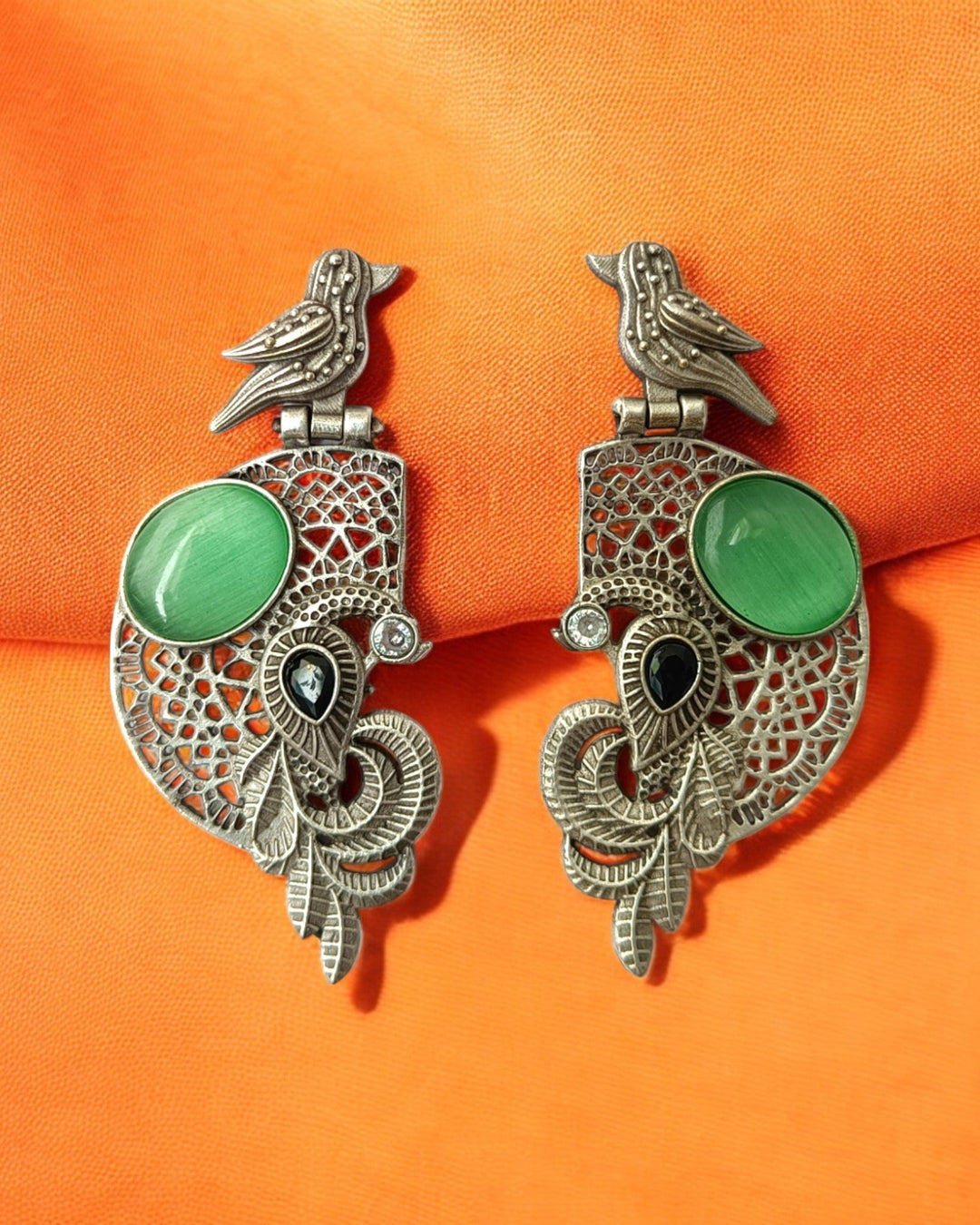 Ornate craftsmanship defines the bird-and-stone earring&