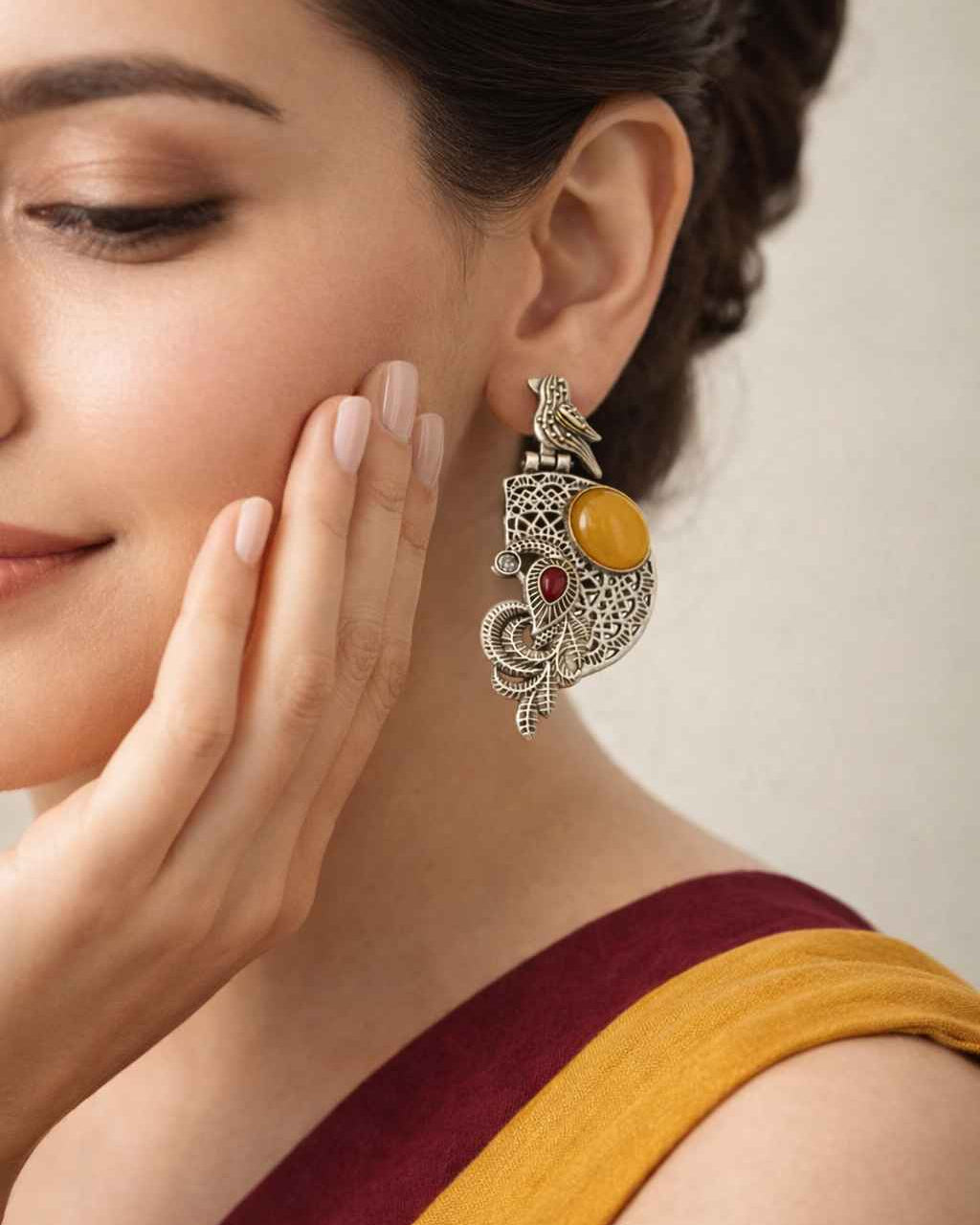 Adira brings a bird motif to this silver oxidised earring.