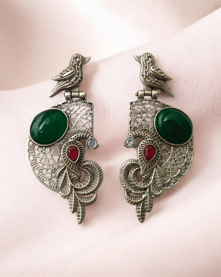 Stone accents highlight the bird motif of this earring.