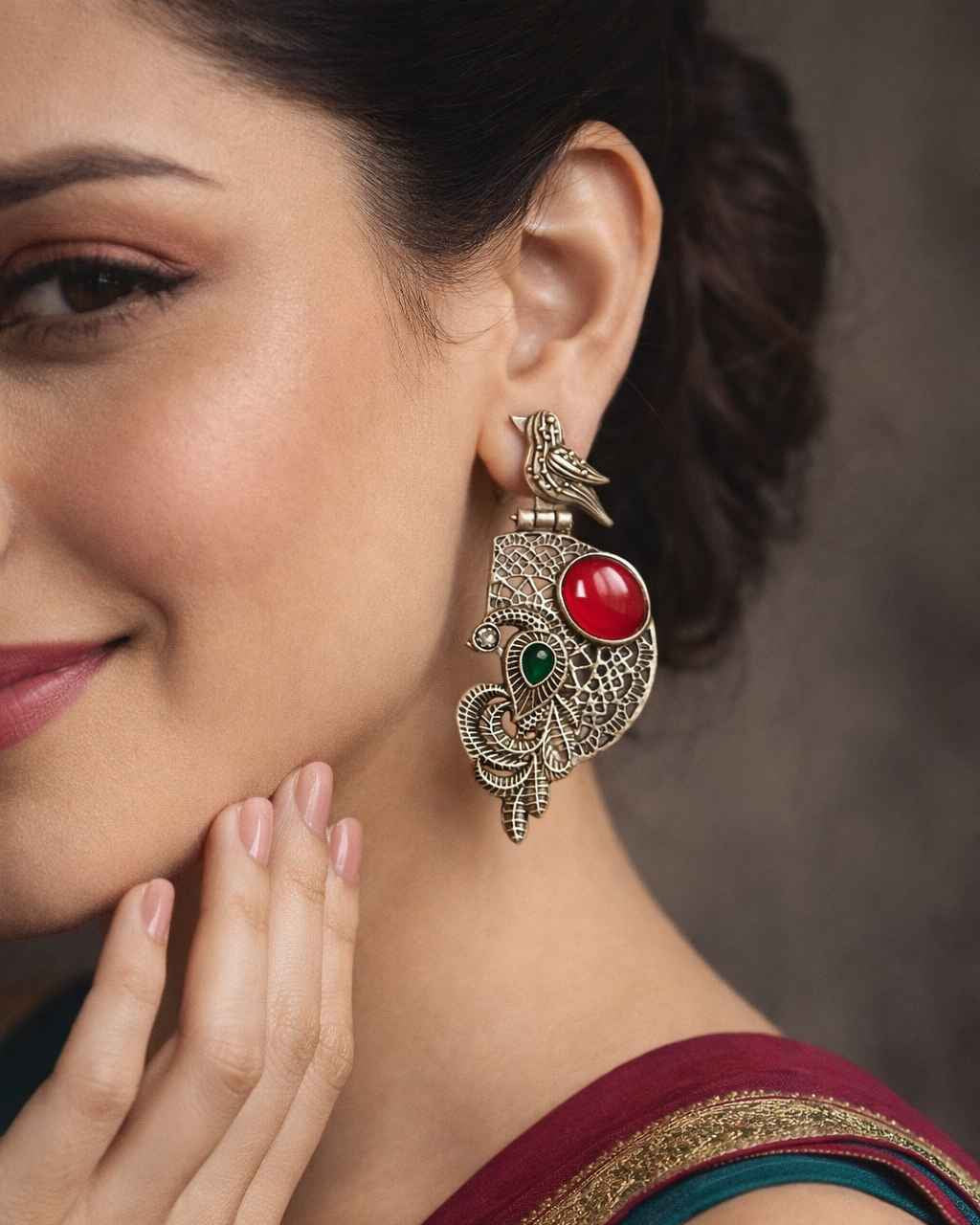 Vibrant stone accents add colour to this oxidised earring.