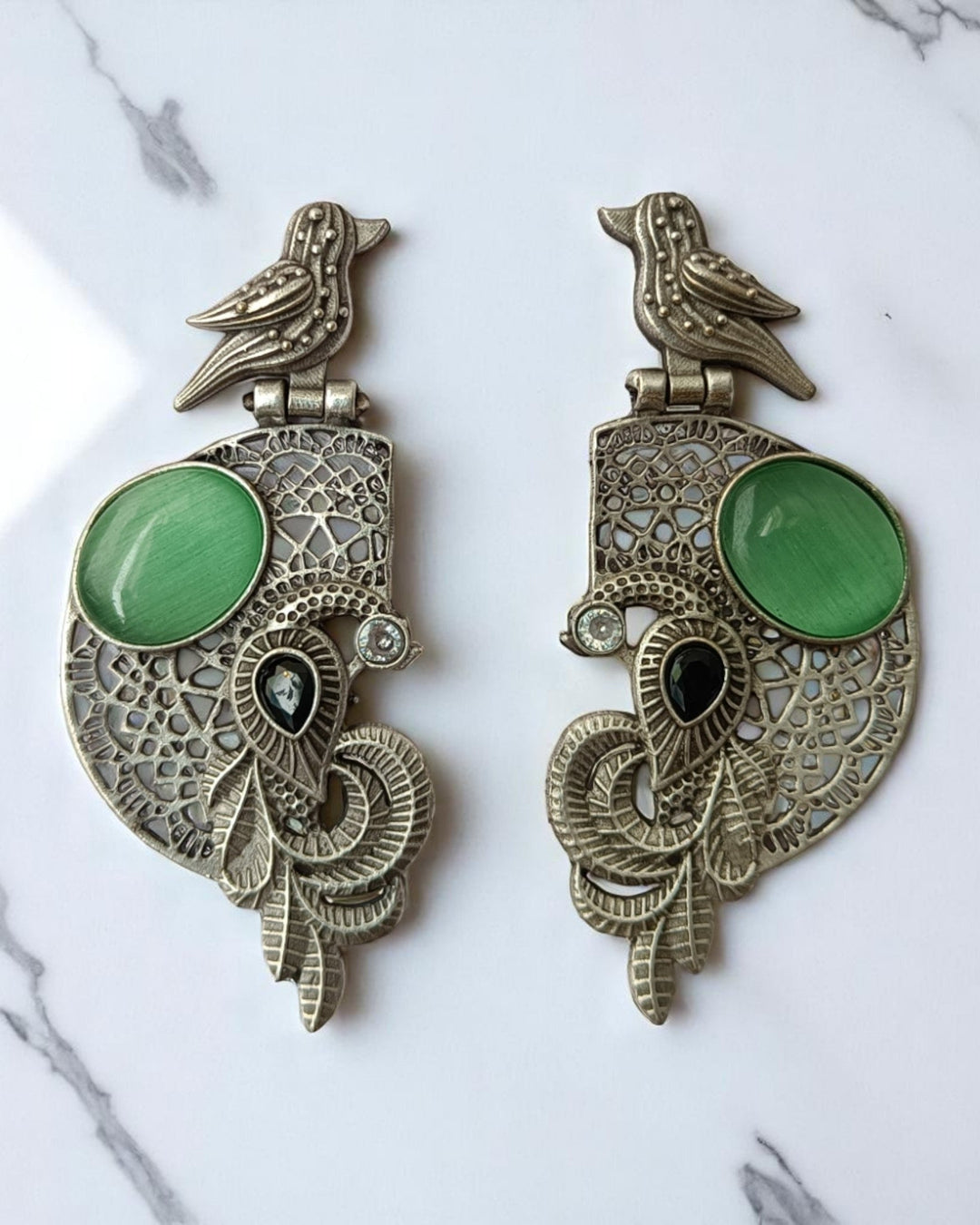 Motif detailing shapes the silhouette of this bird earring.