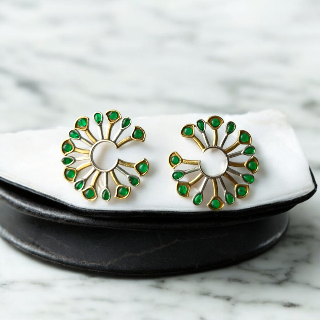 Dual-tone plating covers the surface of this peacock fan earring.