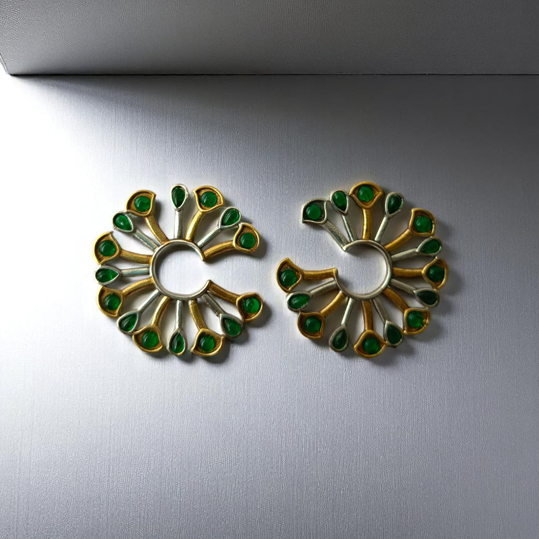 Fan-shaped silhouette defines the peacock motif of this earring.