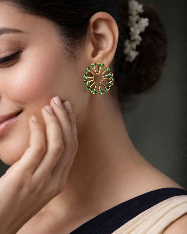 Green accent brings colour to this dual-tone peacock earring.