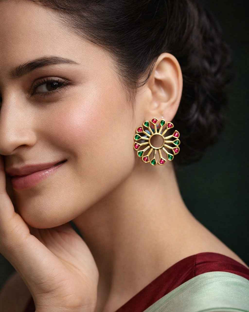 Iridescent peacock fan detailing shapes the silhouette of this earring.