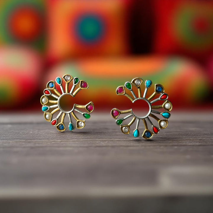 Red accent brings colour to this dual-tone peacock earring.