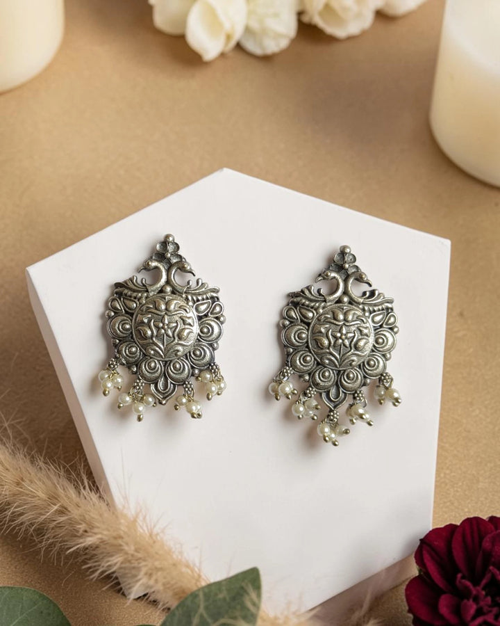 Antiqued finish gives this statement earring its timeless charm.