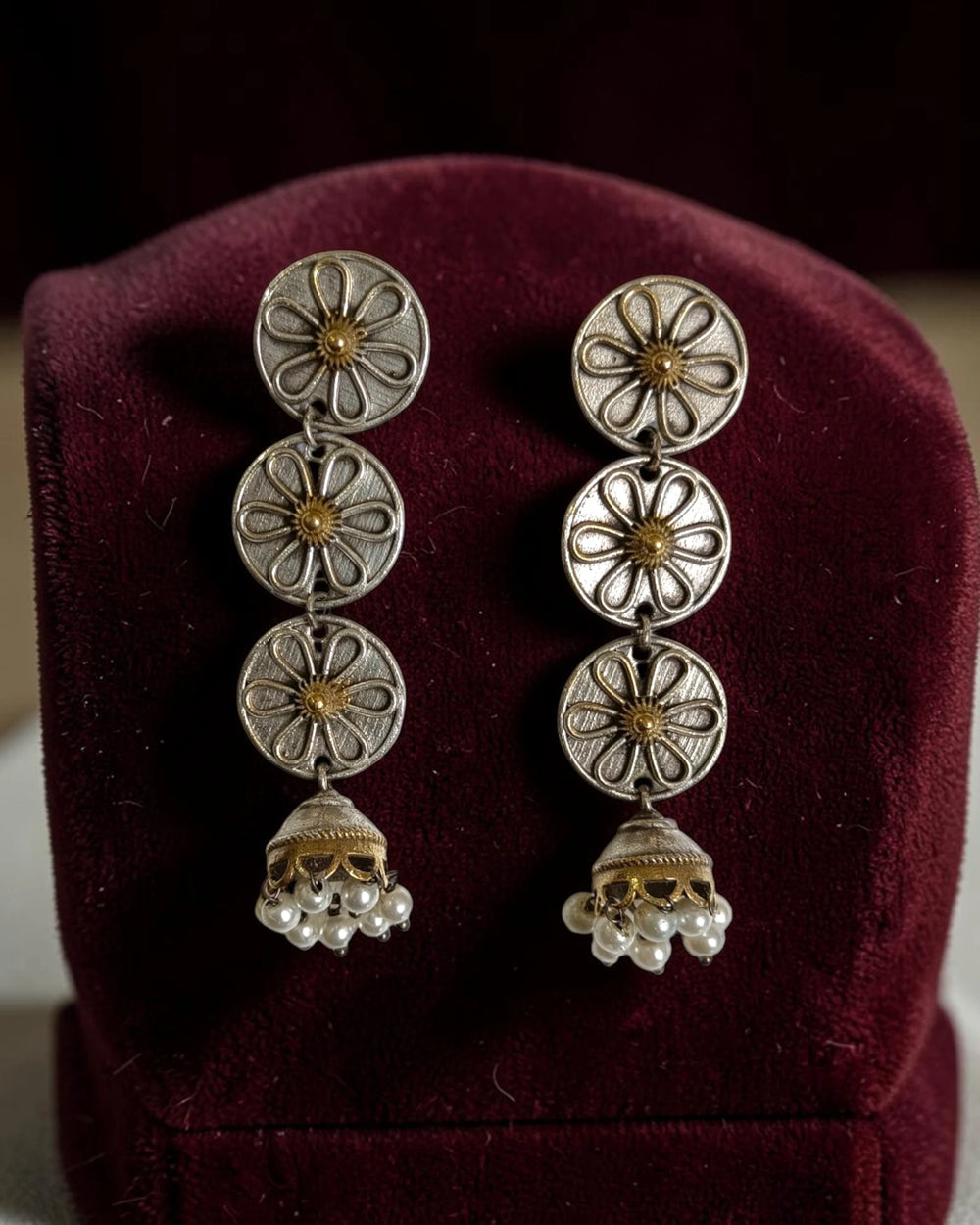 Delicate floral detailing decorates the surface of each disc.