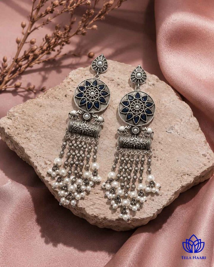 Brass construction supports the soft teardrop shape of this earring.