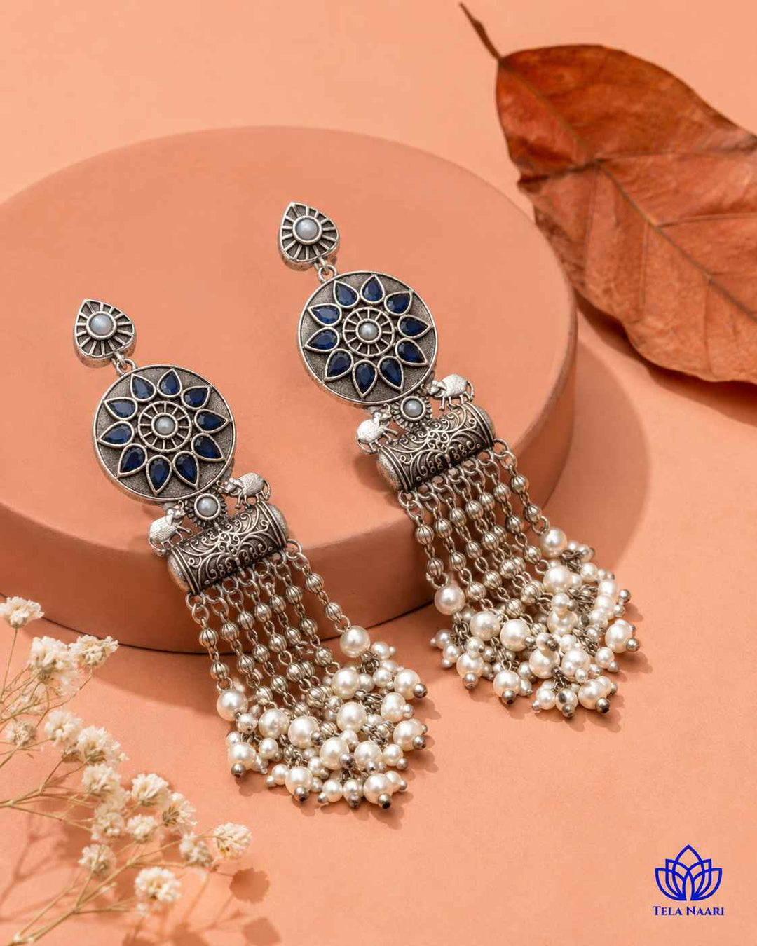 Delicate stone work highlights the blue tones of this earring.