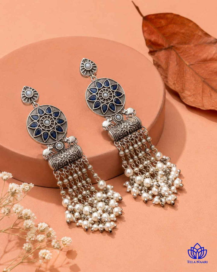 Delicate stone work highlights the blue tones of this earring.