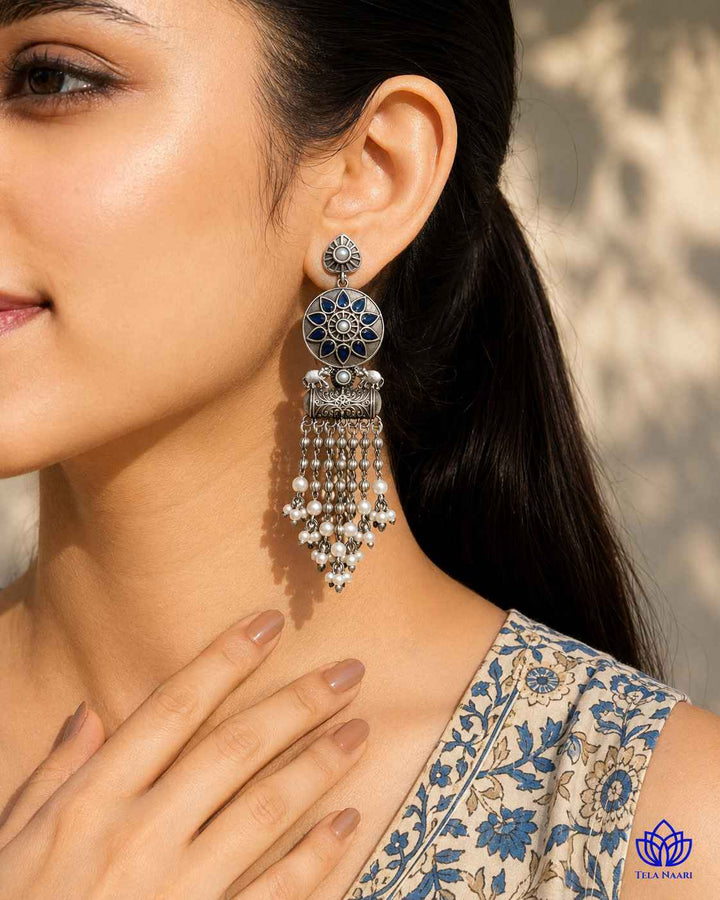 Teardrop silhouette pairs a silver-plated finish with blue tones.